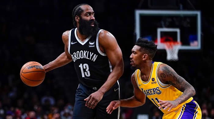 Los Angeles Lakers' Malik Monk (11) defends Brooklyn Nets' James Harden (13) during the second half of an NBA basketball game Tuesday, Jan. 25, 2022 in New York. The Lakers won 106-96. (AP Photo/Frank Franklin II)
